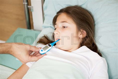 Doctor Taking Body Temperature Of Her Patient Stock Image Colourbox
