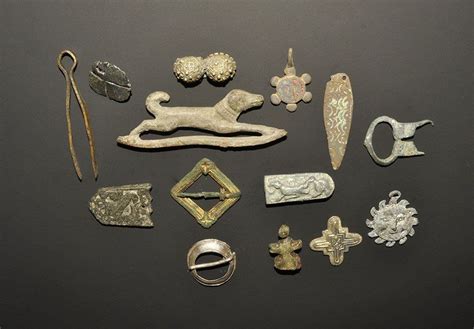 An Assortment Of Antique Silver Items Are Displayed On A Black Surface