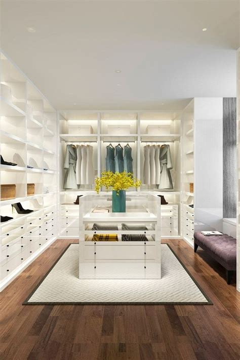 A Walk In Closet Filled With Lots Of White Shelves And Shoes On Top Of Them