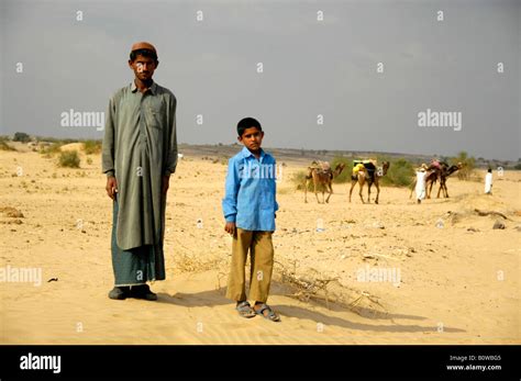 Old Man And Children With Camels In The Desert Hi Res Stock Photography