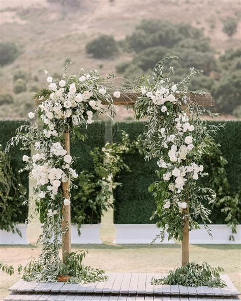 A Voluminous Ceremony Arch Highlights White Roses At Their Finest In Today S Real Wedding