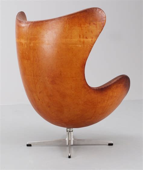 An Arne Jacobsen Brown Leather Egg Chair With Ottoman By Fritz