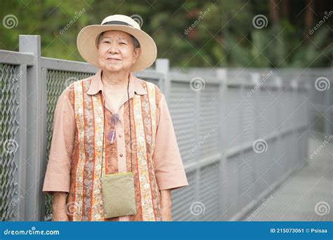 Old Elderly Female Elder Woman Traveller Traveling On Footbridge In