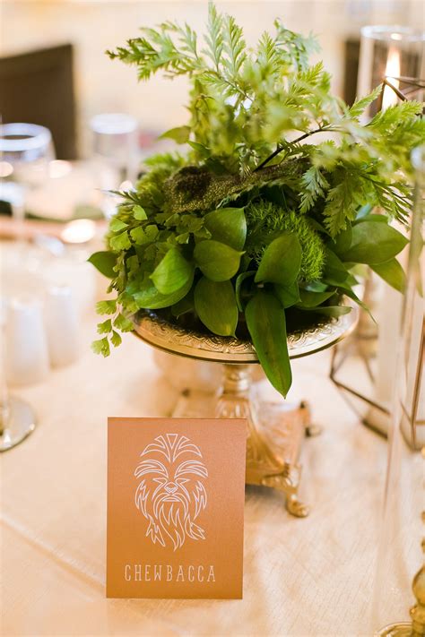 Fern And Moss Centerpieces In Gold Vases