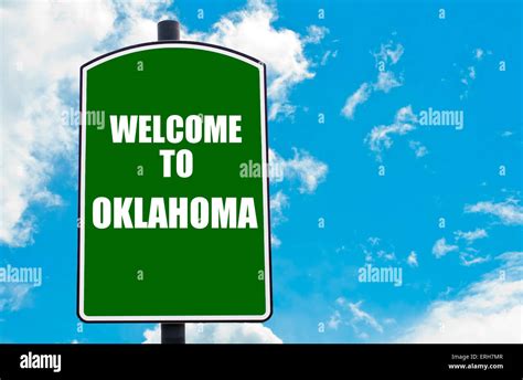 Green Road Sign With Greeting Message Welcome To Oklahoma Isolated Over