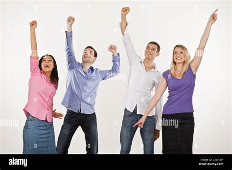 Four Persons Cheering Hands Up Stock Photo Royalty Free Image