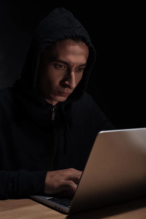 Hacker In Black Hoodie Using Laptop Cuber Security Concept Free Stock