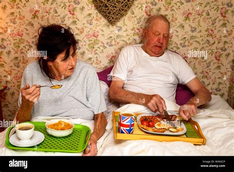 Couple Eating Breakfast In Bed Stock Photo Alamy