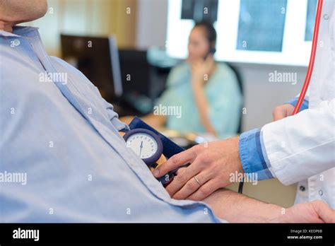 Doctor Taking Patients Blood Pressure Stock Photo Alamy