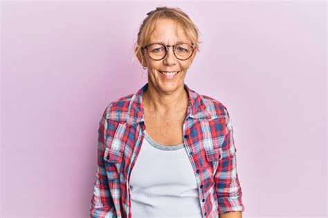 Middle Age Blonde Woman Wearing Casual Clothes And Glasses Gesturing