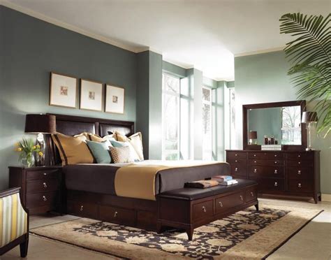 A Bed Room With A Neatly Made Bed And Dressers