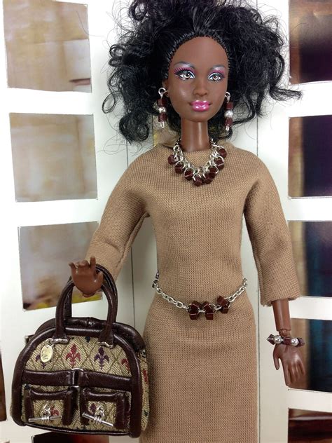 barbie doll holding designer purse and wearing matching jewelry barbie dolls diy barbie