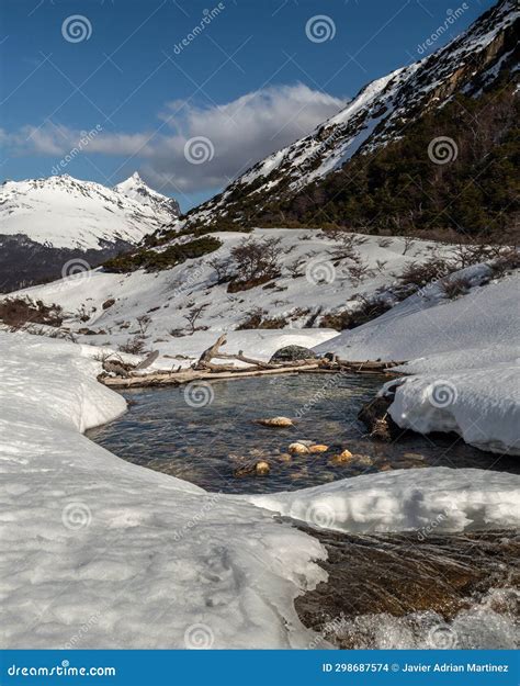 Mountain Range Melting River With Snowy Mountains In The Background