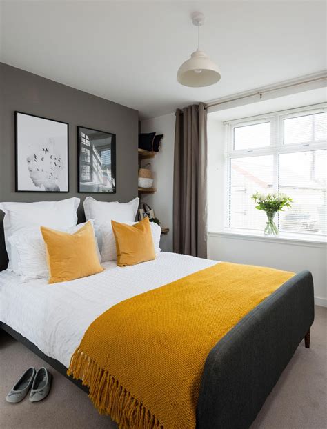 A Master Bedroom In A Grey Colour Scheme With Double Bed Mustard