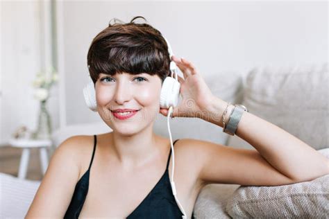 Close Up Portrait Of Lightly Tanned Laughing Girl With Gray Eyes Enjoying Music Indoor Photo Of