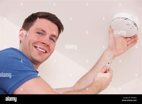 Man Installing Smoke Or Carbon Monoxide Detector Stock Photo Alamy
