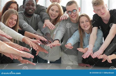 Group Of Smiling Young People Joining Their Hands Stock Photo Image
