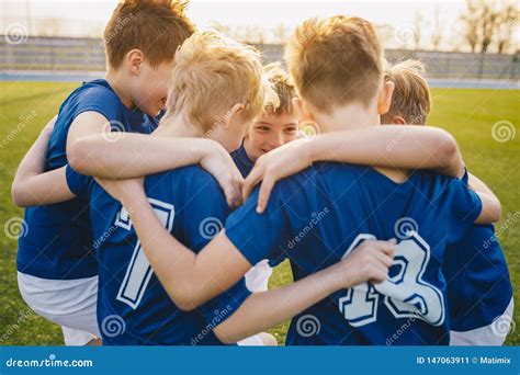 Happy Boys In Junior Football Team Celebrating Success Happy Kids In