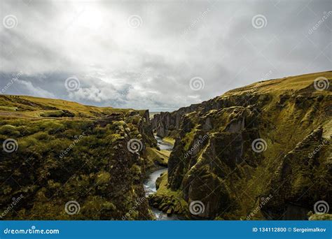 Deep Canyon Steep Cliffs Overgrown With Green Moss Surrounded By A