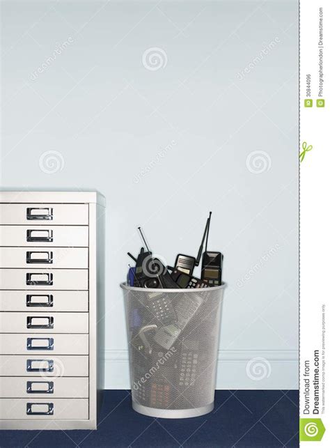 Maybe you would like to learn more about one of these? Mobile Phones In Trash Can By Filing Cabinet Stock Photo ...