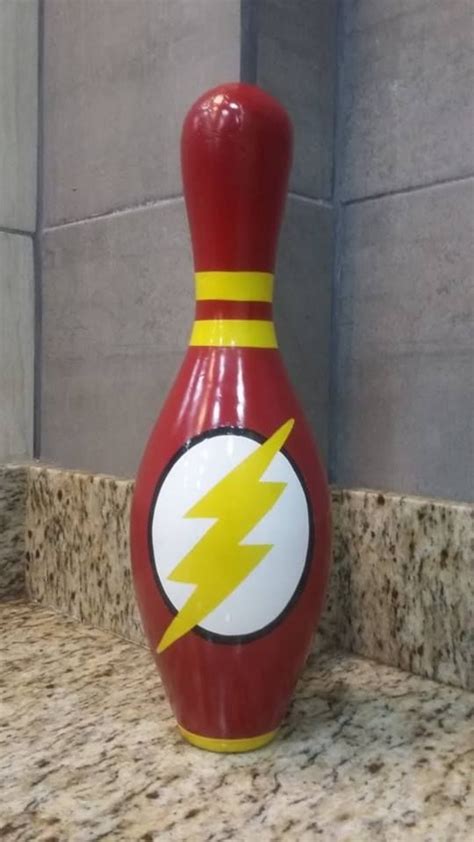 A Red Bowling Ball With A Yellow Lightning Bolt Painted On It Sitting