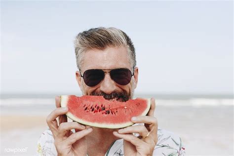 Mature Man Eating Watermelon At The Beach Premium Image By Mature Men Eating