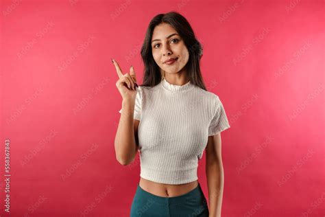 Cute Brunette Woman Wearing White Ribbed Crop Isolated Over Red Background Shaking Index Finger