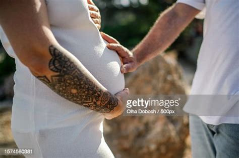 Midsection Of Man Touching Belly Of Pregnant Woman During