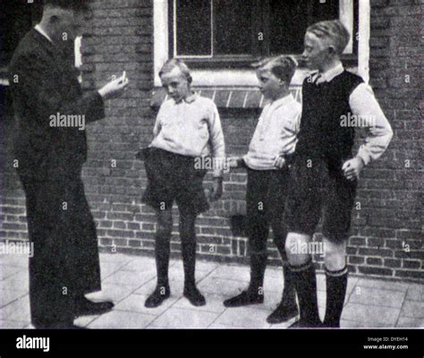 World War Ii A Dutch Teacher Speaks To A Group Of Boys Outside A