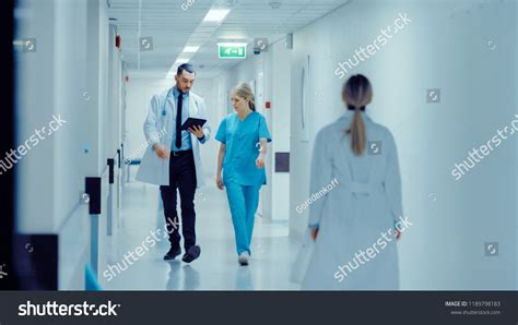 Female Surgeon Doctor Walk Through Hospital Stock Photo Edit Now