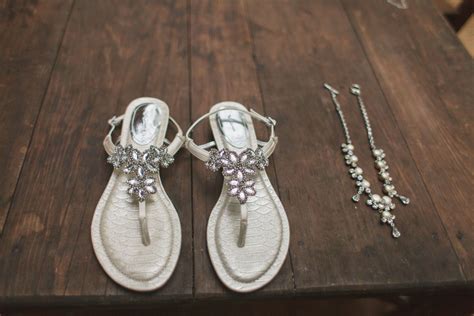 bride sandals with silver shiny flowers wedding venues beach destination wedding wedding party