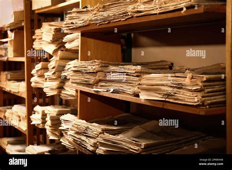 Collection of old newspapers on shelves in library Stock Photo - Alamy