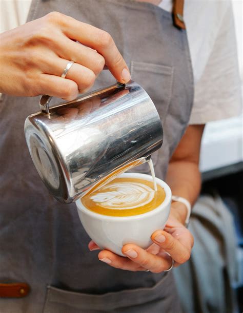 Woman Making Latte Art In Coffee · Free Stock Photo