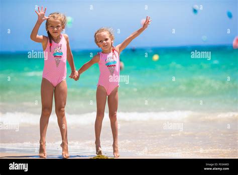Adorable Little Girls Having Fun During Beach Vacation Stock Photo