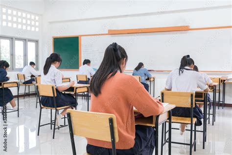 Writing Test In Exam With Behind Girl Asian Students Group Concentrate