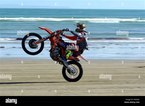 Beach Motocross Weymouth Beach Motocross Racing Motocross Rider Performing A Wheelie Stock