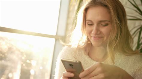 smiling-woman-texting-sms-on-smartphone-happy-woman-holding-phone-ant