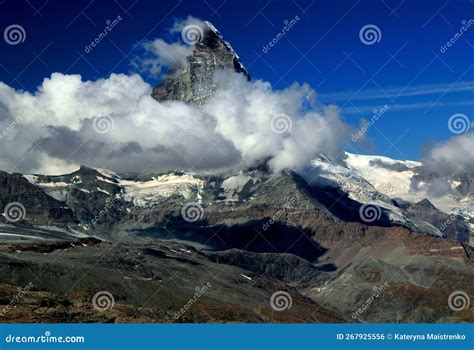 Landscape With A Mountain Matterhorn View Partially Covered By Clouds