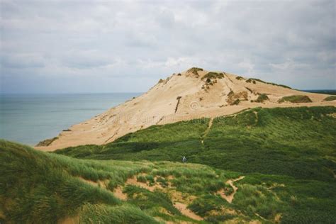 Landscape With A Dune Mountain Blue Sky And A Green Dune Stock Photo