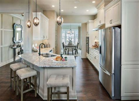 The island allows you to divide. Traditional white cabinet kitchen with angled peninsula ...