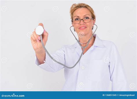 portrait of happy mature woman doctor using stethoscope stock image image of coat