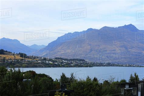 Queenstown With Mountains Against Cloudy Sky Stock Photo Dissolve