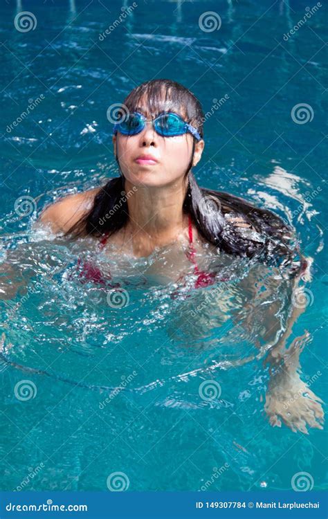 Pretty Asian Woman Wearing Red Bikini With Waterproof Glasses Swimming At Swimming Pool Stock