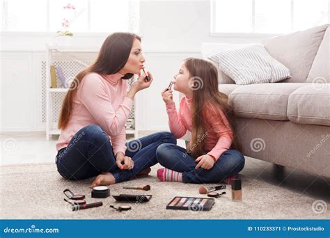 mother and daughter doing makeup sitting on the floor stock image image of happiness daughter