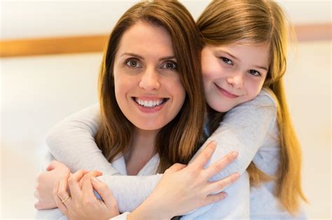 free photo portrait of mother and daughter embracing each other