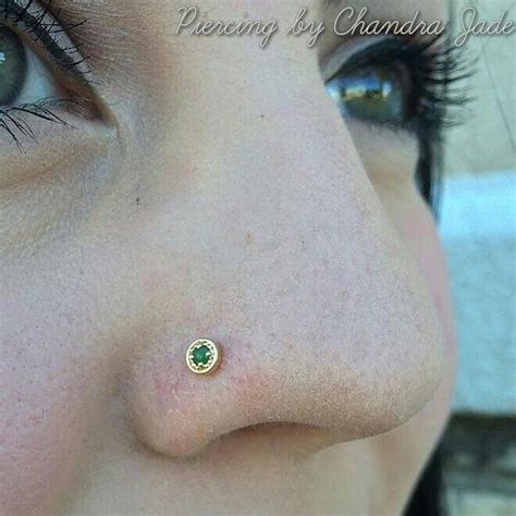 A Womans Nose Has A Tiny Green Stone In The Middle Of Her Nose