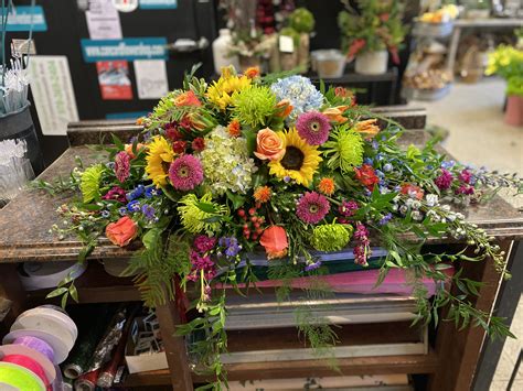Vibrant flowers in memory of a vibrant lady | Casket sprays, Vibrant flower, Funeral basket