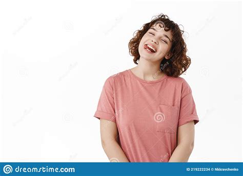 portrait of attractive happy woman girl shows tongue smiles and laughs tilts head carefree
