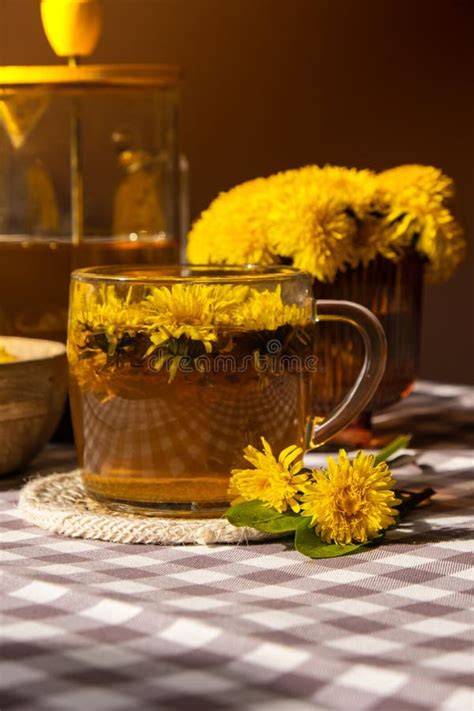 Dandelion Flower Healthy Tea In Glass Teapot And Glass Cup On Table