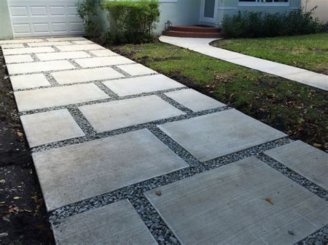 Concrete Paver Staggered Squares Design With 1 Gray Granite Rocks